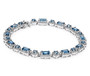 side view of london blue topaz and white zircon halo tennis bracelet in rhodium over sterling silver