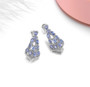 full view of tanzanite and white zircon dangle earrings in rhodium over sterling silver