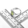 peridot and white zircon three stone ring in rhodium over sterling silver shown for size comparison
