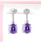 amethyst and white zircon dangle earrings in rhodium over sterling silver shown in a lifestyle photo