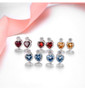 full view of blue topaz and white zircon heart stud earrings in rhodium over sterling silver
