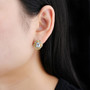 sky blue topaz citrine and peridot earrings in rhodium over sterling silver worn on the ear