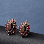 close up of black garnet halo earrings in rhodium over sterling silver