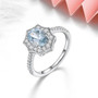 aquamarine and white zircon halo ring in rhodium over sterling silver shown in a lifestyle photo