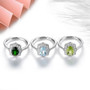 close up of aquamarine and white zircon halo ring in rhodium over sterling silver