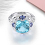 front view of sky blue topaz tanzanite and white zircon statement ring in rhodium over sterling silver