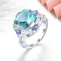 sky blue topaz tanzanite and white zircon statement ring in rhodium over sterling silver shown in a lifestyle photo