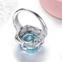 back view of sky blue topaz tanzanite and white zircon statement ring in rhodium over sterling silver