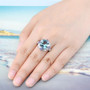 sky blue topaz tanzanite and white zircon statement ring in rhodium over sterling silver worn on a hand