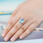 sky blue topaz and white zircon ring in 18k rose gold over sterling silver worn on a hand