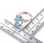 sky blue topaz and white zircon ring in 18k rose gold over sterling silver shown for size comparison