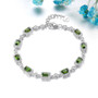 chrome diopside and white zircon halo adjustable tennis bracelet in rhodium over sterling silver shown in a lifestyle photo
