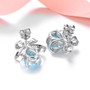 back view of sky blue topaz and white zircon bow earrings in rhodium over sterling silver