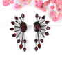 garnet cluster statement earrings in rhodium over sterling silver shown in a lifestyle photo