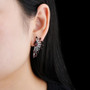 garnet cluster statement earrings in rhodium over sterling silver worn on the ear