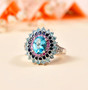 blue apatite multi color sapphire and zircon halo ring in rhodium over sterling silver shown in a lifestyle photo