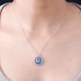 blue apatite multi color sapphire and zircon halo pendant necklace in rhodium over sterling silver worn around the neck