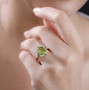 peridot chrome diopside and zircon halo ring in 18k yellow gold over sterling silver worn on a hand