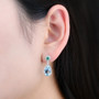 sky blue topaz emerald and white zircon dangle earrings in rhodium over sterling silver