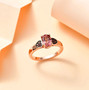 pink tourmaline and brown zircon heart ring in 18k rose gold over sterling silver shown in a lifestyle photo