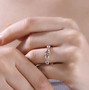 pink tourmaline and moissanite ring in 18k rose gold and rhodium over sterling silver worn on a hand