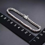 natural black garnet tennis bracelet in rhodium over sterling silver shown for size comparison