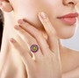 peridot and rhodolite garnet halo ring in rhodium over sterling silver worn on a hand