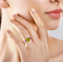 peridot rhodolite garnet and zircon butterfly ring in rhodium over sterling silver worn on a hand