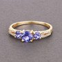 tanzanite and diamond trilogy ring in solid 14k yellow gold shown in a lifestyle photo