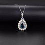 close up of blue topaz and pearl pendant necklace in rhodium over sterling silver