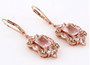 side view of rose quartz and lab sapphire dangle earrings in 18k rose gold over sterling silver