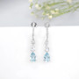 close up of aquamarine and white zircon dangle earrings in rhodium over sterling silver