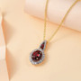 garnet and white zircon pendant necklace in 18k yellow gold over sterling silver shown in a lifestyle photo