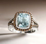 aquamarine brown and white diamond double halo ring in 14k white gold shown in a lifestyle photo