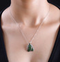 chrome diopside and white zircon frog pendant necklace in rhodium over sterling silver worn around the neck