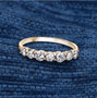 white diamond seven stone band ring in solid 14k yellow gold shown in a lifestyle photo