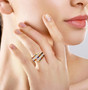 multi color sapphire and moissanite bypass ring in 18k yellow gold over sterling silver worn on a hand