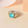 blue and green quartz triplet peridot and zircon ring in 18k yellow gold and rhodium over sterling silver shown in a lifestyle photo