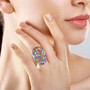multi color sapphire and moissanite cluster ring in rhodium over sterling silver worn on a hand