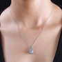 aquamarine blue sapphire and white zircon pendant necklace in rhodium over sterling silver worn around the neck