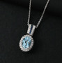 aquamarine blue sapphire and white zircon pendant necklace in rhodium over sterling silver shown in a lifestyle photo