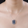 blue diamond cluster pendant necklace in rhodium over sterling silver worn around the neck