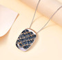 blue diamond cluster pendant necklace in rhodium over sterling silver shown in a lifestyle photo