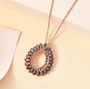 champagne diamond pendant necklace in 18k rose gold over sterling silver shown in a lifestyle photo