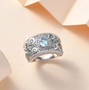 blue apatite and moissanite band ring in rhodium over sterling silver shown in a lifestyle photo
