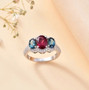 rubellite tourmaline indicolite tourmaline and moissanite three stone halo ring in rhodium over sterling silver shown in a lifestyle photo