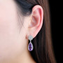amethyst and white zircon pear drop earrings in rhodium over sterling silver on ear model