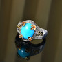 turquoise fire opal and zircon two-tone ring in 18k yellow gold and rhodium over sterling silver shown in a lifestyle photo