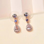 morganite tanzanite and zircon dangle earrings in 18k rose gold over sterling silver shown in a lifestyle photo