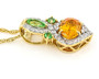 side view of spessartine garnet tsavorite garnet and diamond pendant necklace in 14k yellow gold